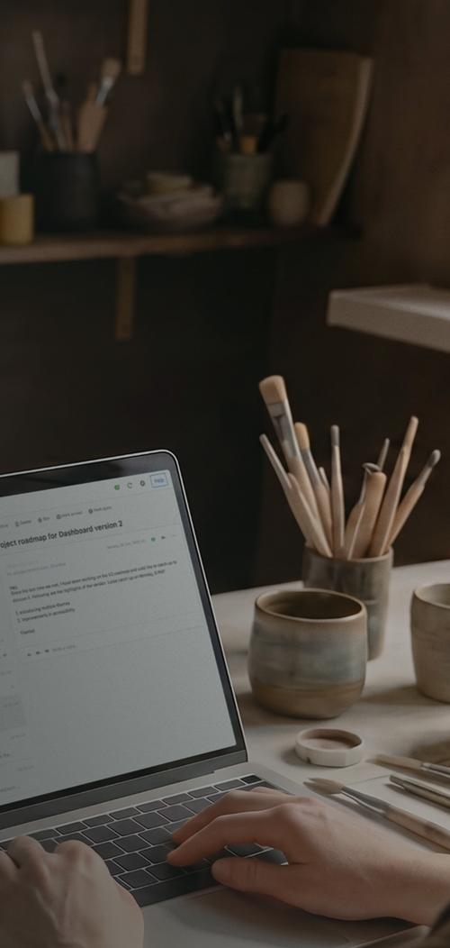 An image of an artist using a laptop with the Titan mailbox UI.
