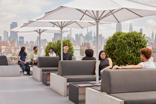 People having a discussion on a roof deck