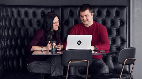 People looking at a laptop screen.