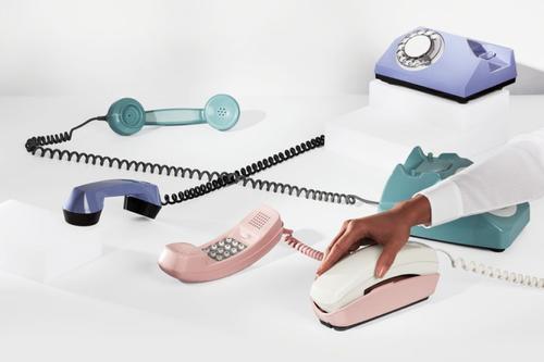 Numerous colorful corded phones