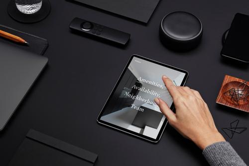 Desk objects and iPad displaying website built with Squarespace Enterprise