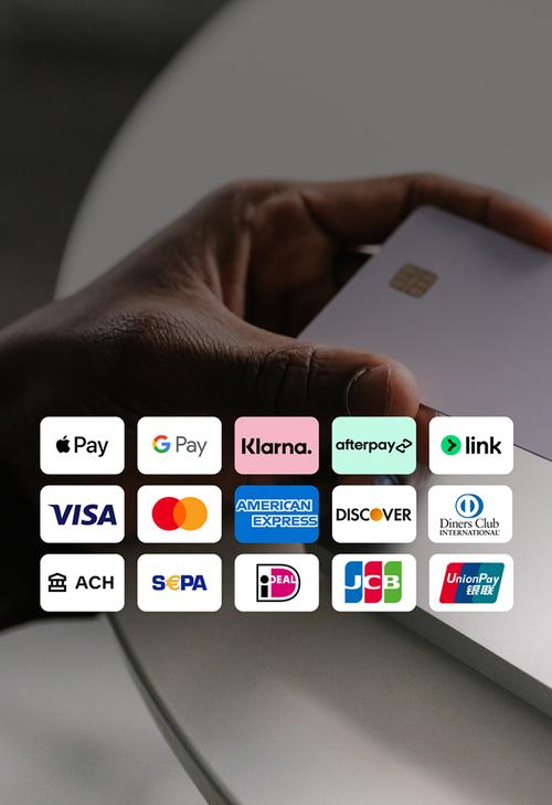 Hand holding a white payment card near a laptop keyboard. Overlay shows a grid of accepted payment methods.