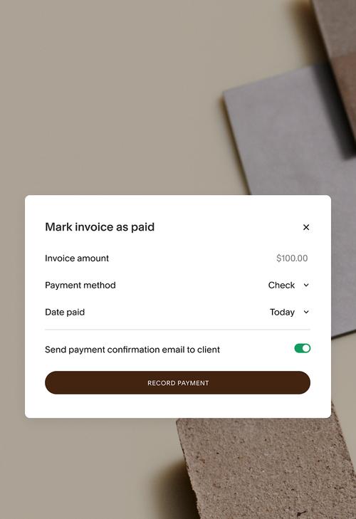 Mark invoice as paid screen displaying $100 payment by check, with confirmation email option enabled.