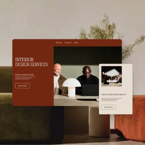 An interior design services website mockup with a "Book now" button, overlaid on a photo of two people collaborating at a desk with a laptop.