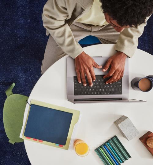 Hand holding pen over desk