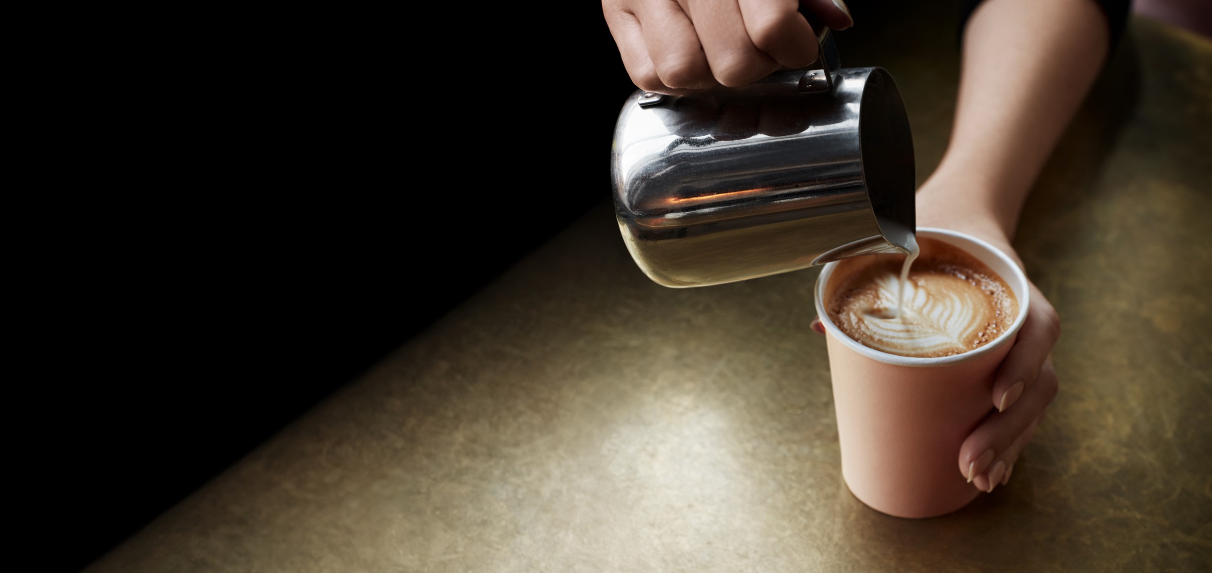 Barista pouring a cup of coffee.