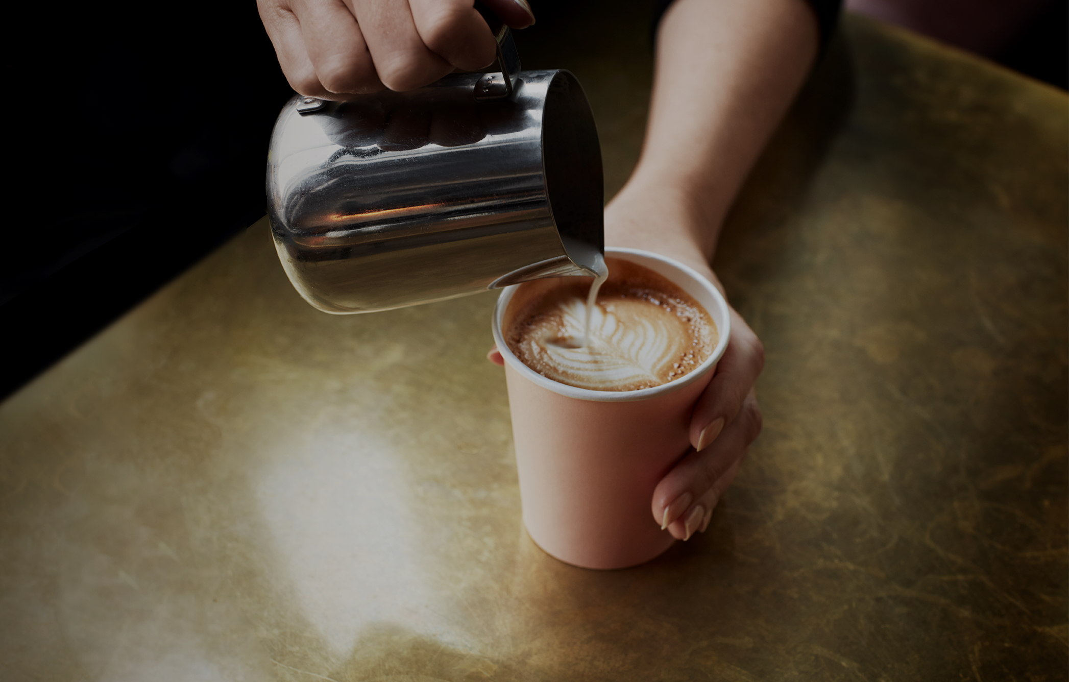 Barista pouring a cup of coffee.