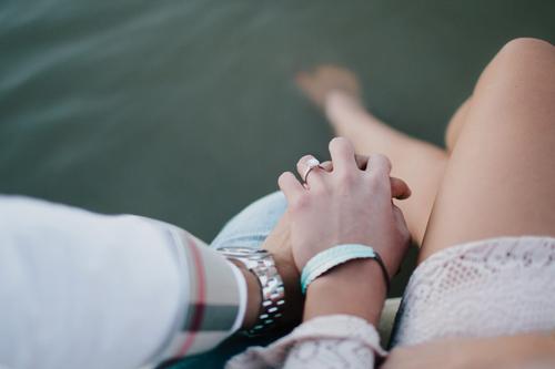 Close-up of a couple holding hands.